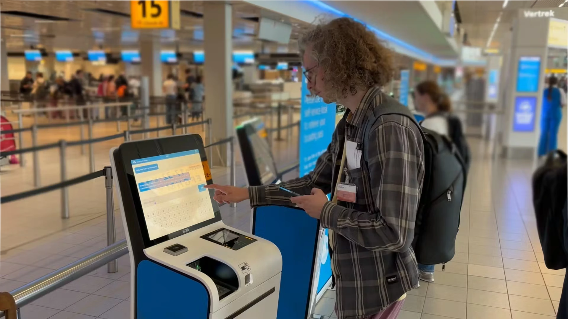 KLM ticket kiosk supporting traveler at airport.